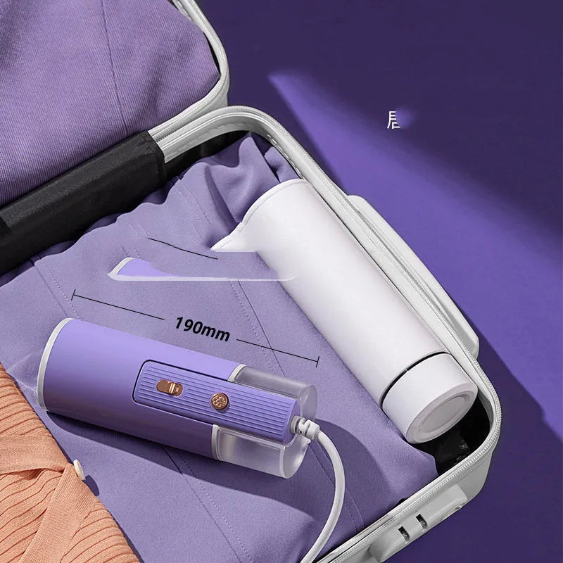 Portable handheld garment steamer in grey lotus root purple colour, shown with foldable design and water filling opening.