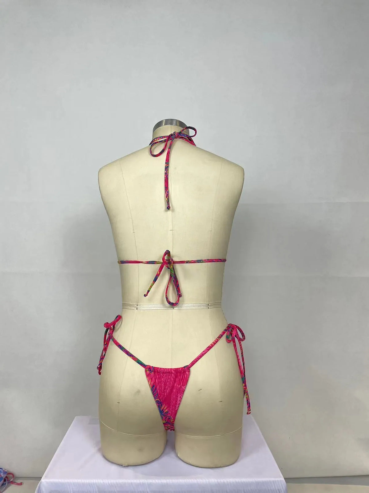 Pink printed women's bikini two-piece set with brief triangle style, shown from front.
