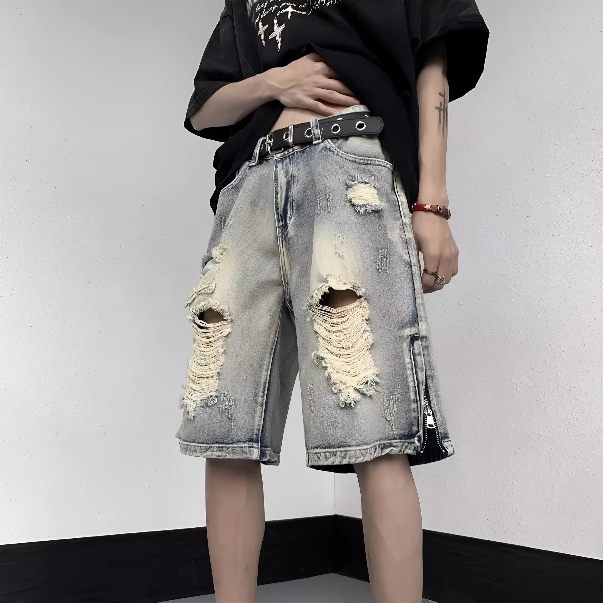 Blue retro tattered denim shorts with a wide leg loose fit on a neutral background.