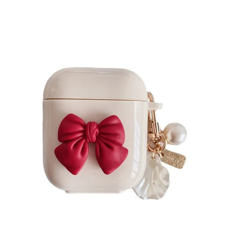 Beige TPU clamshell earphone case with a red bow design for AirPods.
