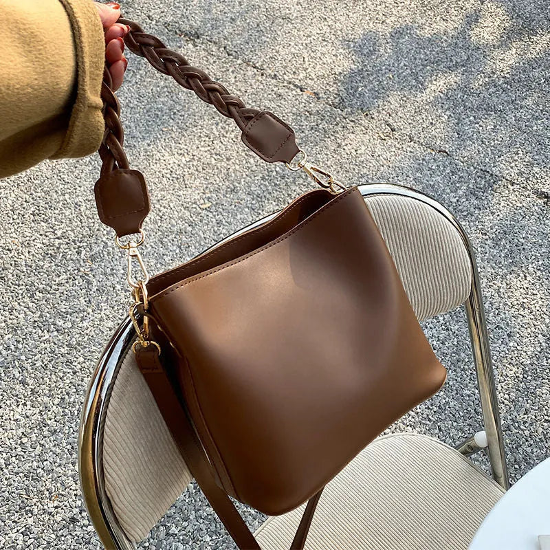 Fashion retro one-shoulder crossbody underarm bucket bag in woven PU with adjustable strap, shown in khaki colour.