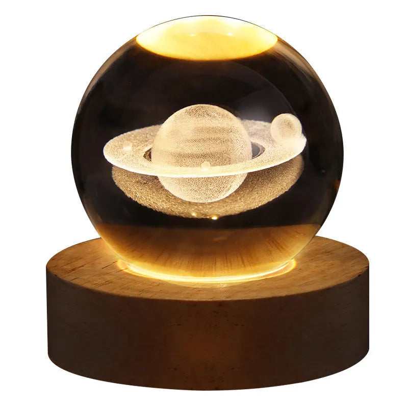 3D crystal ball night light projecting starry sky and planets from its 6cm sphere on a solid wood base.