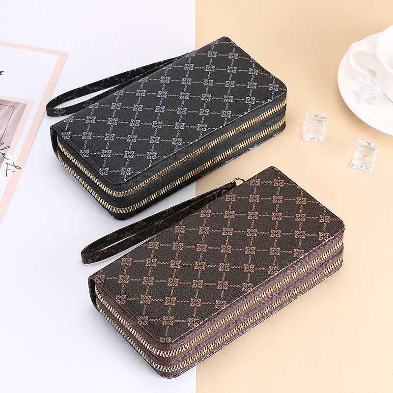 Retro style long wallet clutch in PU leather with a print design, shown in black colour.