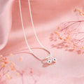 Silver cherry necklace with adjustable snake bone chain and detailed fruit pendant on a model