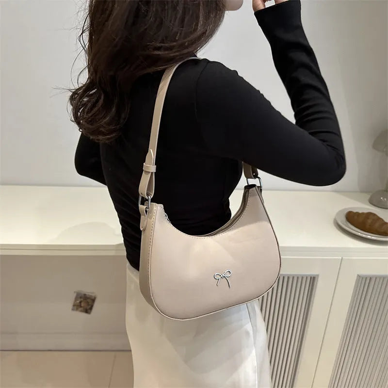 Women's PU dumpling-shaped underarm baguette handbag in six colours with a single strap.