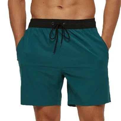 Men's blue athletic shorts with multiple pockets, drawstring waistband, and stitching detail for running and fitness activities