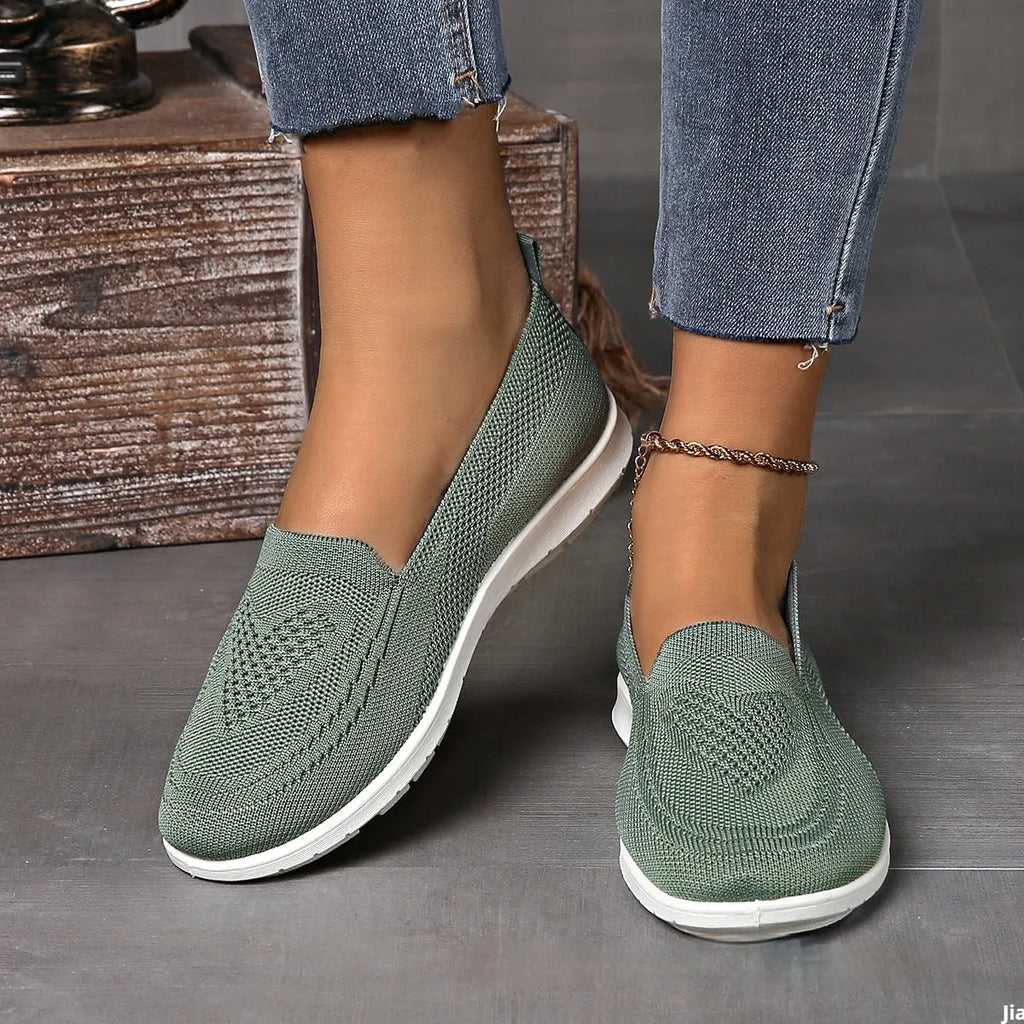 Women's plus size beige slip-on cloth shoes with low-cut design and flat sole.