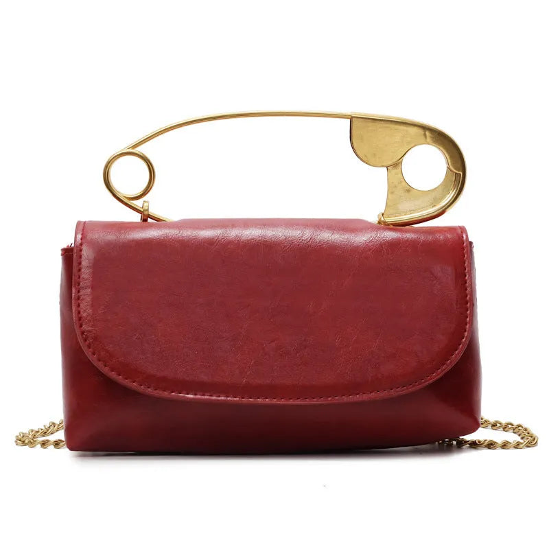 Black street trend shoulder handbag with sandwich pockets and visible sewing thread details.