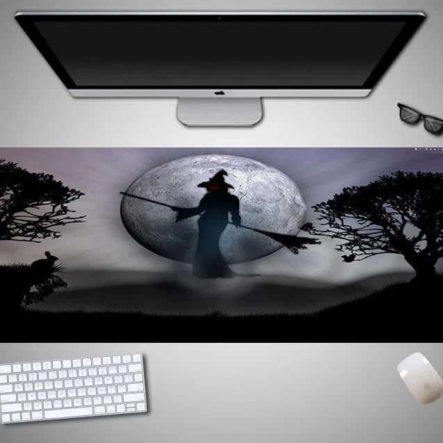 Oversized Halloween-themed mouse pad on desk with non-slip rubber cloth base and large surface area