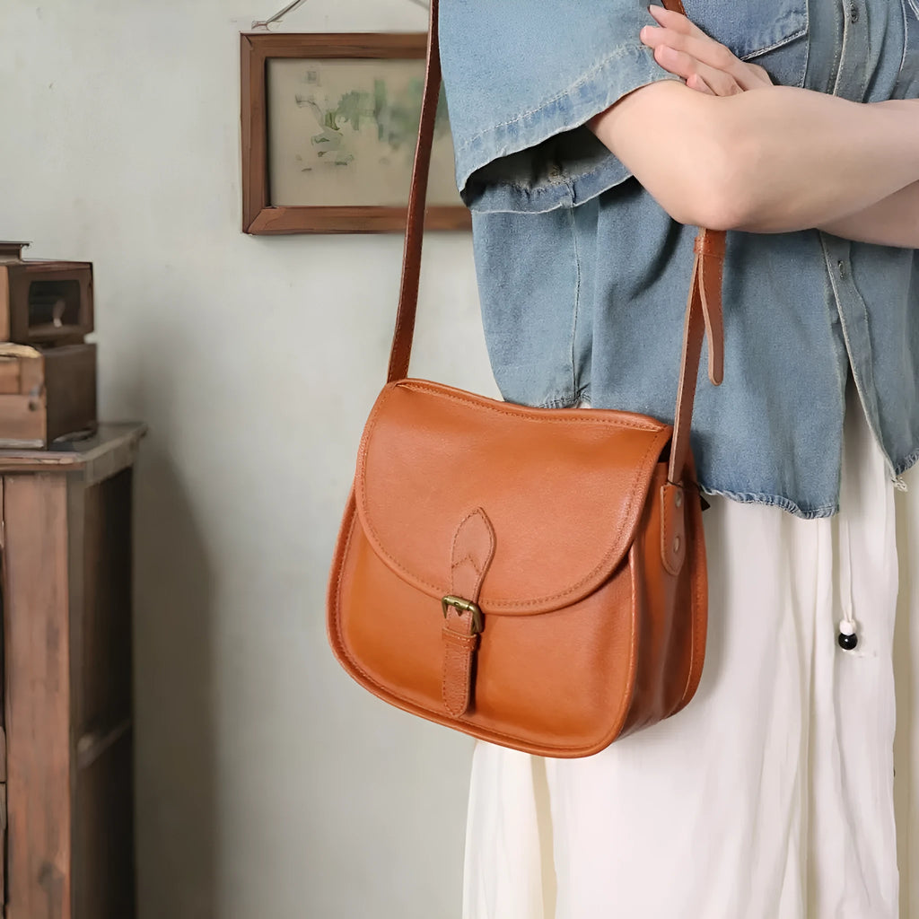 Brown retro-style genuine leather messenger bag with flap closure and crossbody strap