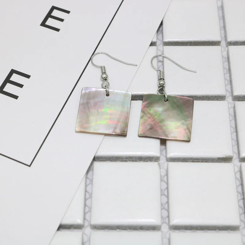Women's geometric shell earrings in square and rectangular designs with natural shell material texture