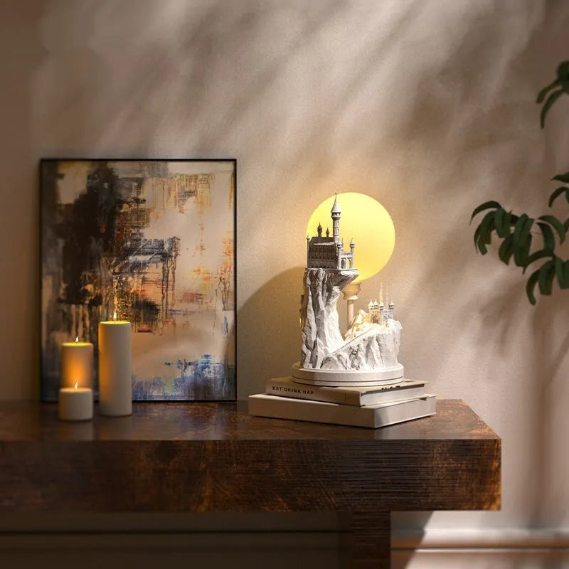 White composite gypsum table lamp with a plug-in cord and wire switch, shown on a bedside table.