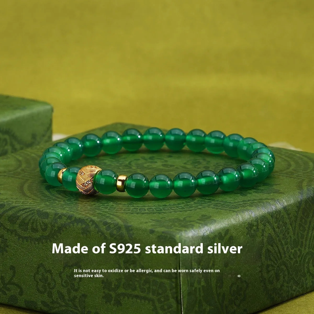 Green agate and sterling silver bracelet with yellow gold plating and a geometric bead.