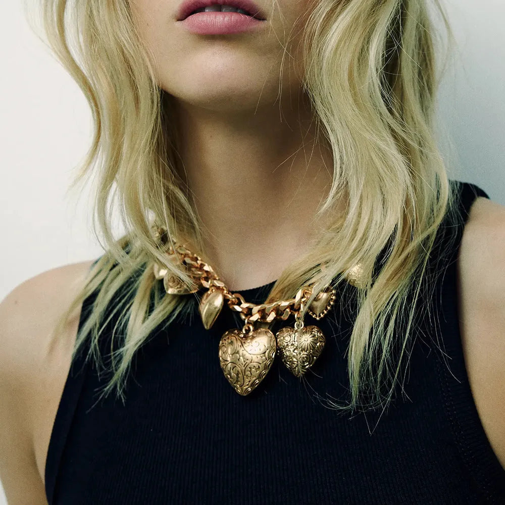 Gold heart pendant necklace with textured dripping oil finish on adjustable chain