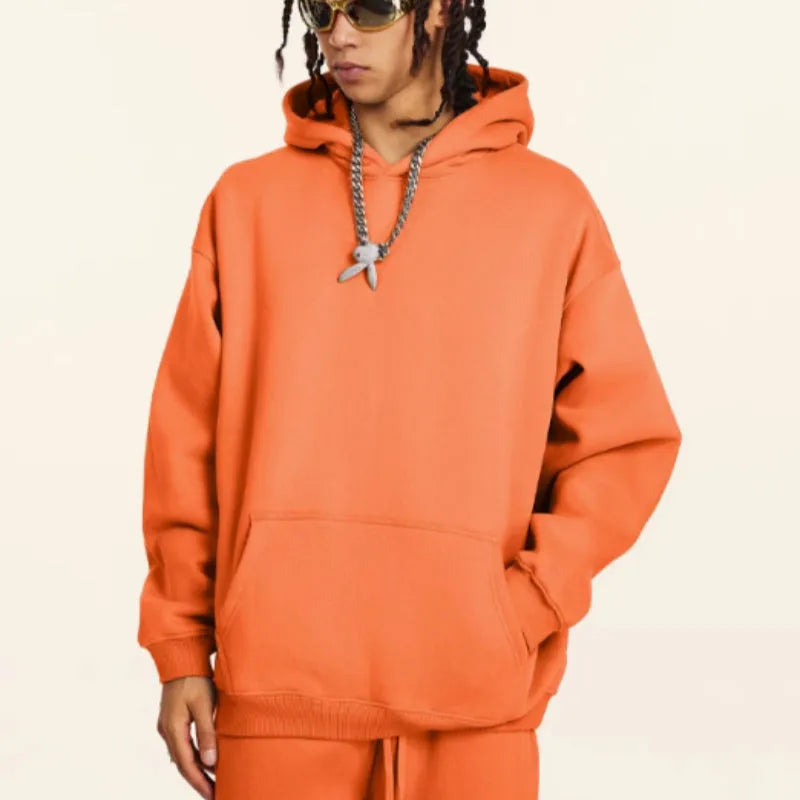 Men's grey terry cotton hooded sweater with drop shoulders on hanger showing texture detail