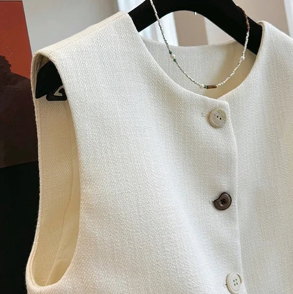 French style round neck sleeveless vest in milky white colour, showing bandage-style construction and polyester fabric texture