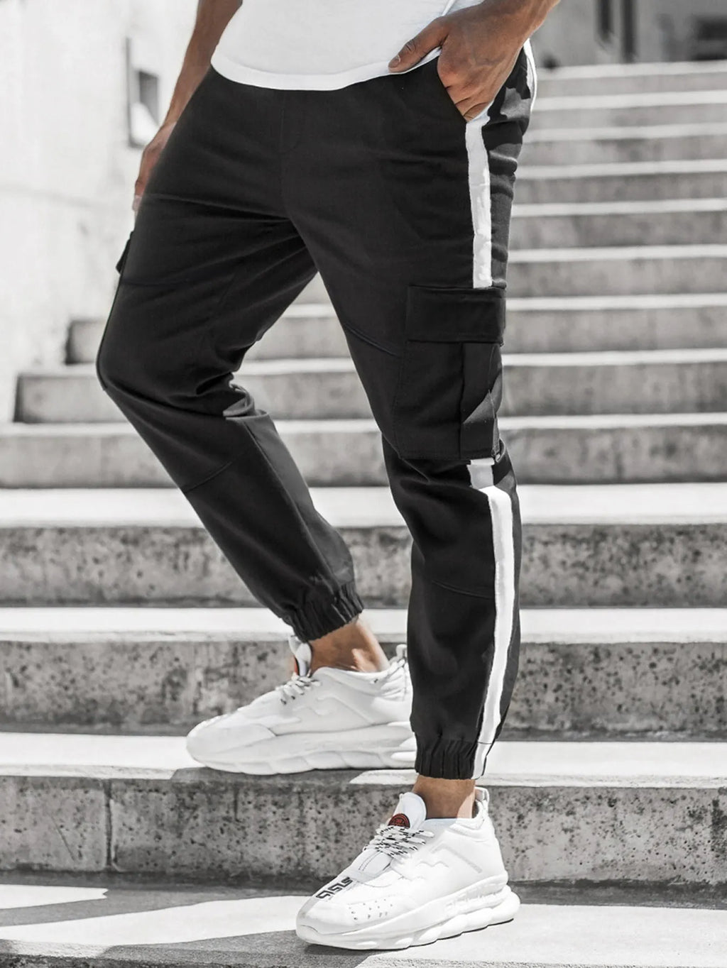 Men's leather-look casual trousers in khaki, black, or dark grey with middle waist and zip fly.