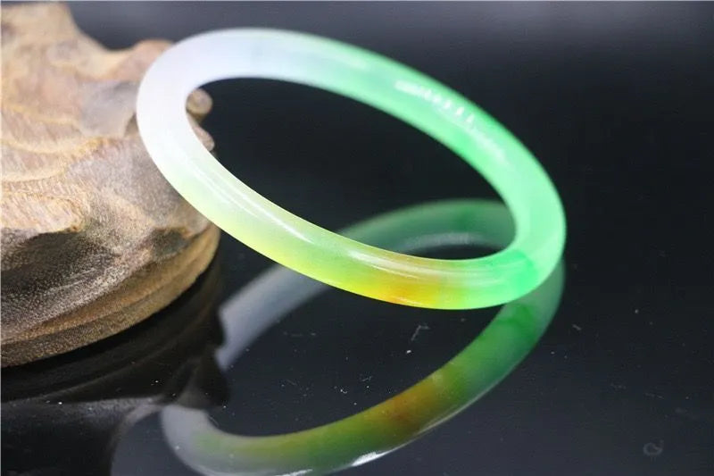 Women's jade bracelet with ice-like emerald appearance and floating flower patterns in multiple colour options