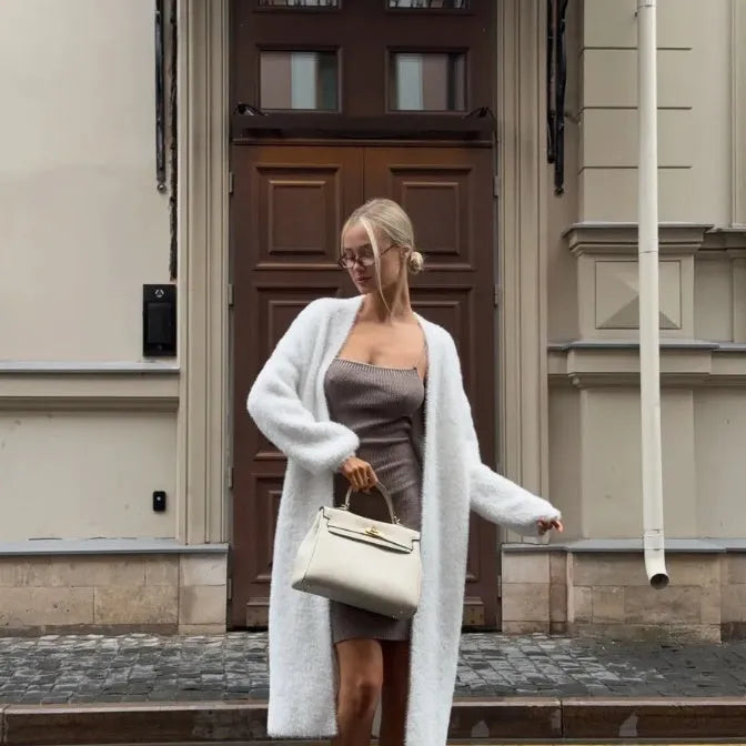 White women's knitted cardigan jacket with 105cm length and loose fit, shown in commute style
