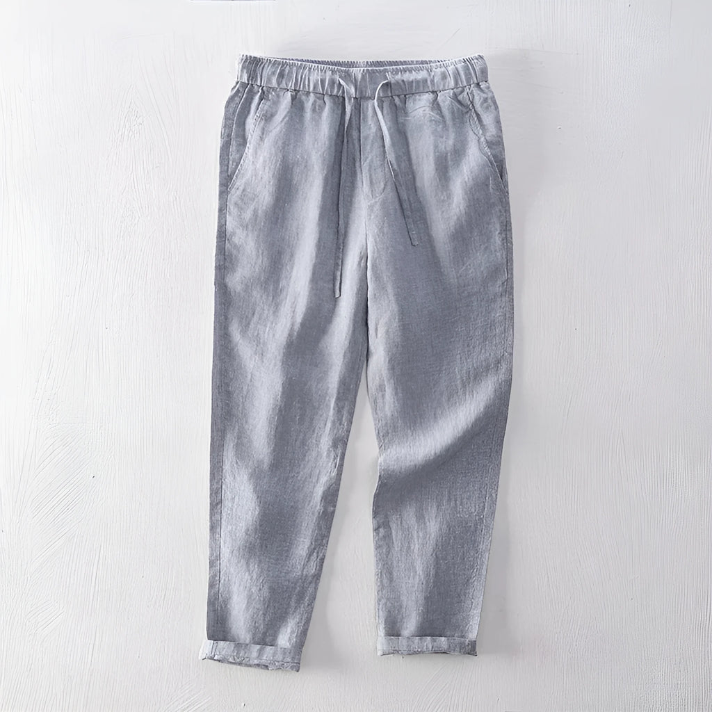 Men's straight-leg linen trousers in dark grey, showing the mid-waist and relaxed leg fit