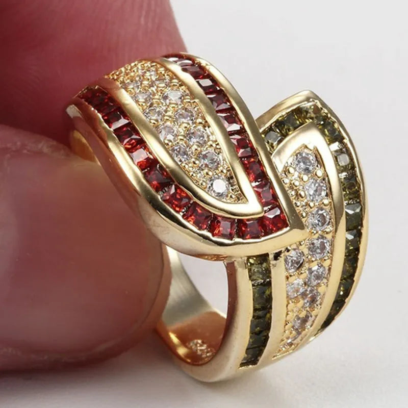 Gold-coloured women's alloy ring with a central green peridot stone on a model's finger.