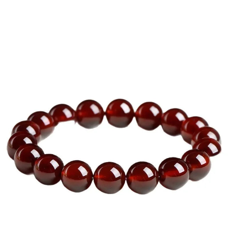 Natural orange red garnet crystal ball bracelet with retro Ruyi design on wrist