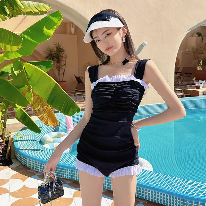 Women's solid colour one-piece swimsuit with suspender straps in jumpsuit design