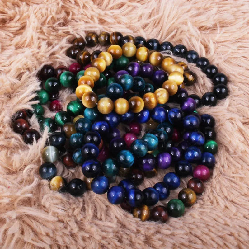 Natural tiger eye crystal bracelet with round beads in dark blue colour, showing tiger eye banding patterns
