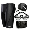 Men's black swimming set with briefs, goggles, cap, ear plugs, nose clip, and a carry bag laid out.
