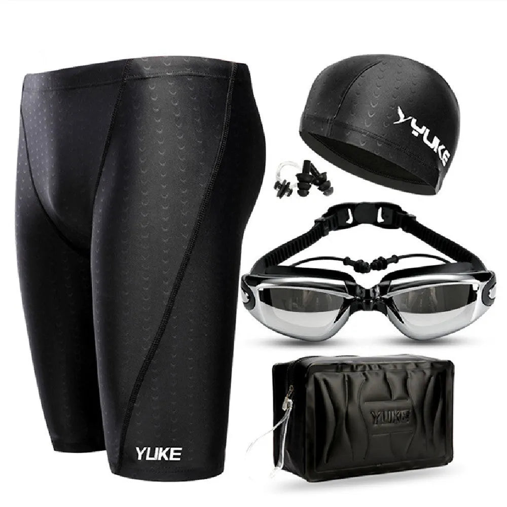 Men's black swimming set with briefs, goggles, cap, ear plugs, nose clip, and a carry bag laid out.