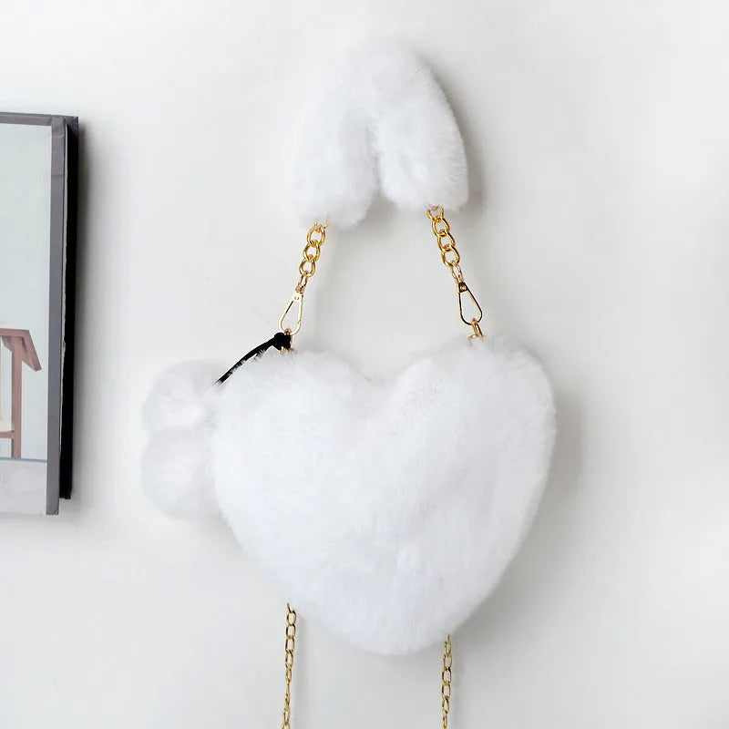 Women's plush heart-shaped handbag with single adjustable strap in various solid colours