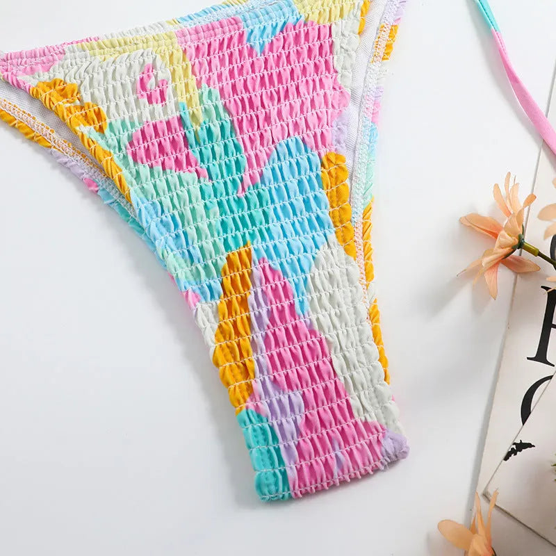 Women's multicolour floral triangle bikini with smocking detail on the top and briefs bottom.
