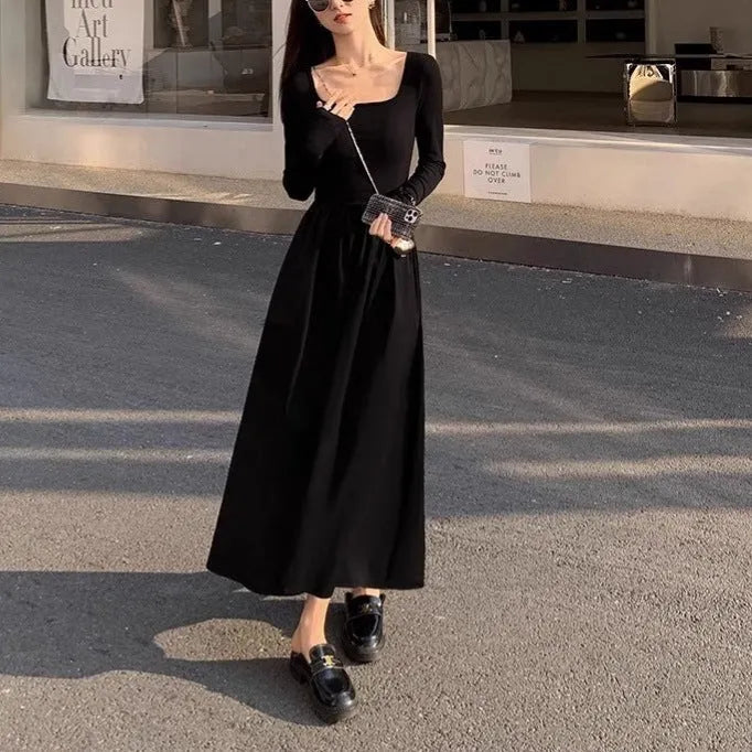 Women's black square collar knitted dress with elastic waist and long A-line skirt, made from polyester fabric.