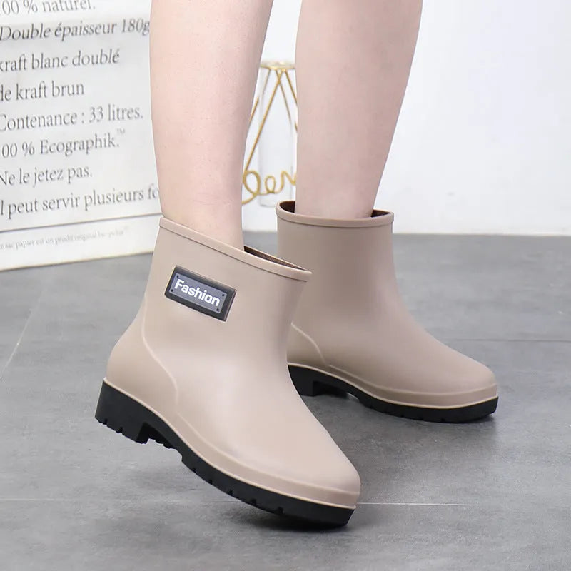 Women's PVC mid-calf rain boots in black, brown, apricot, and purple colours