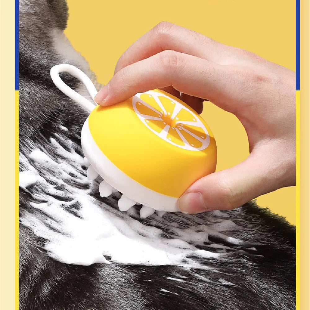 Yellow silicone pet bath brush with massage nodes and comb teeth on a white background.