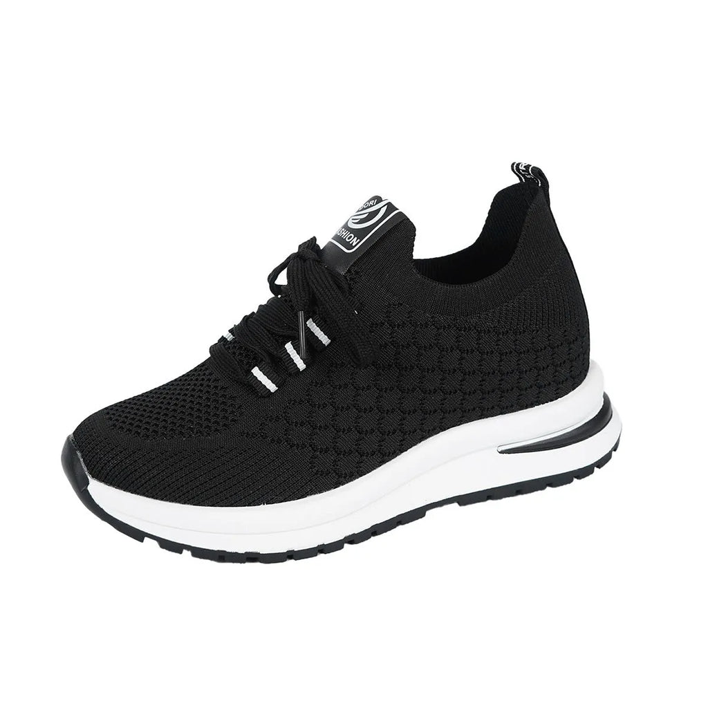 Women's black and white flat lace-up mesh sneakers on a white background