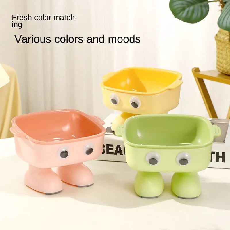 Green robot-shaped elevated cat bowl with tilted design and detachable inner food container