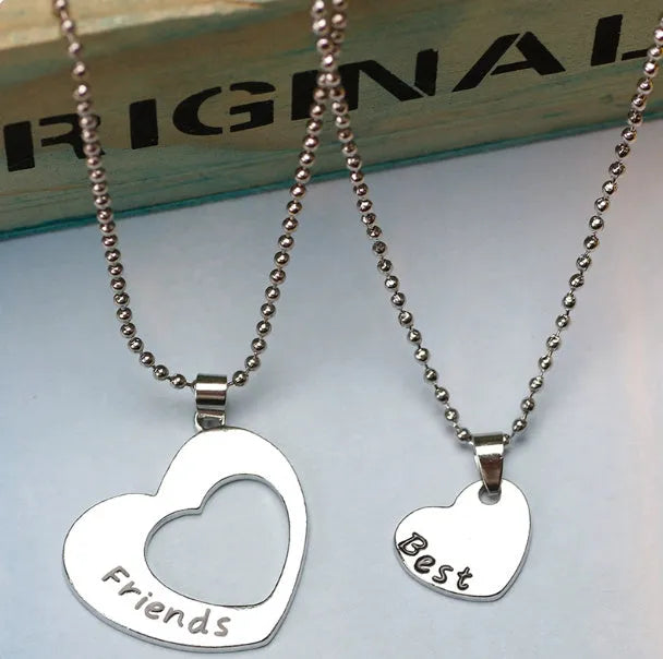 Two-piece silver alloy necklace set with heart-shaped pendants and cross chains in a love design