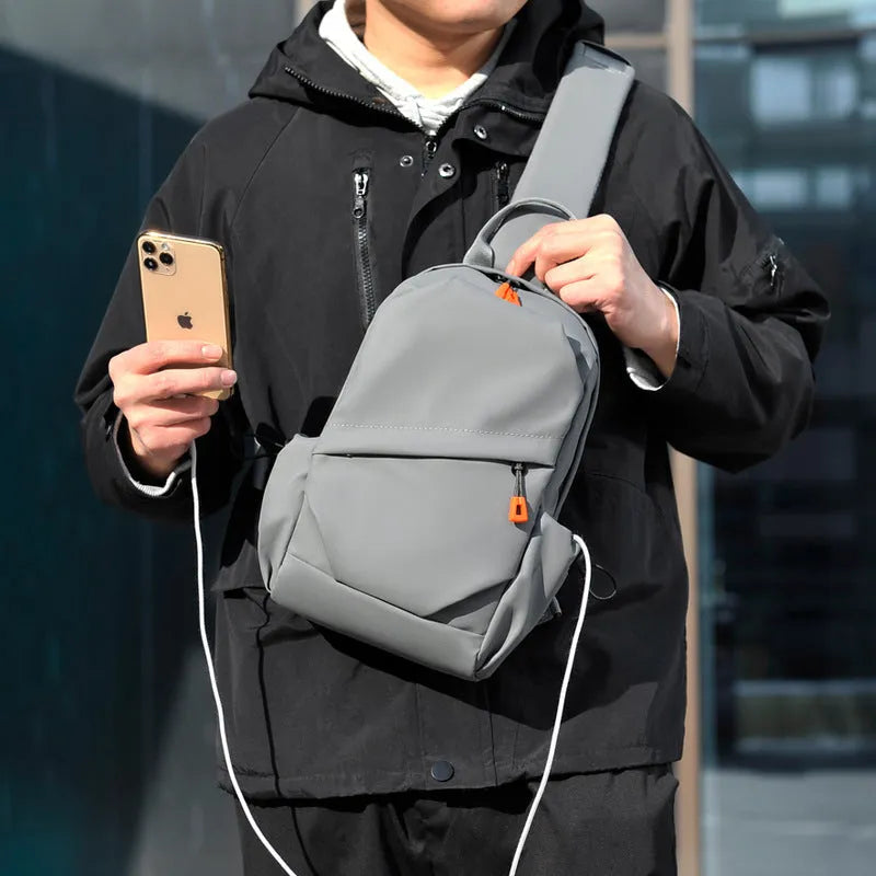 Black mens crossbody bag with adjustable strap showing waterproof polyester material