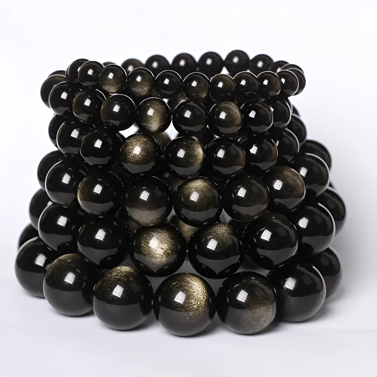 Hand-woven obsidian bracelet with round beads in adjustable sizes from 8mm to 16mm diameter, showing six colour options including black stone and rainbow eye obsidian.