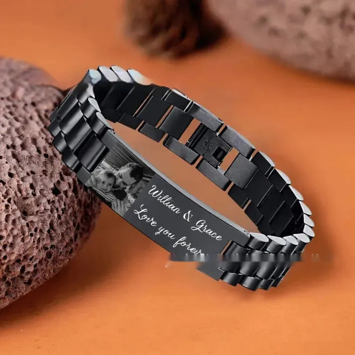 Titanium steel heart-shaped bracelet with black lettering on a curved band.
