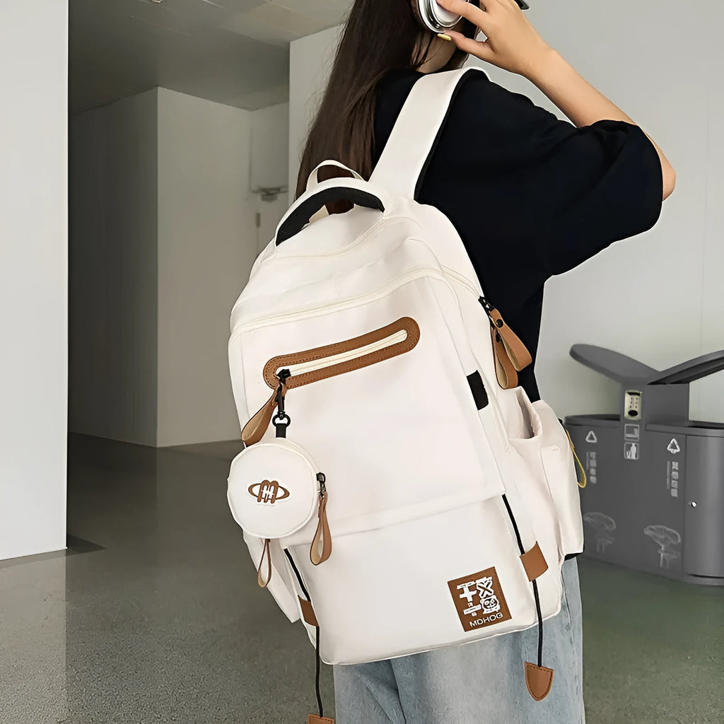 Large waterproof travel backpack in black with contrast colour stitching showing 20-35 litre capacity