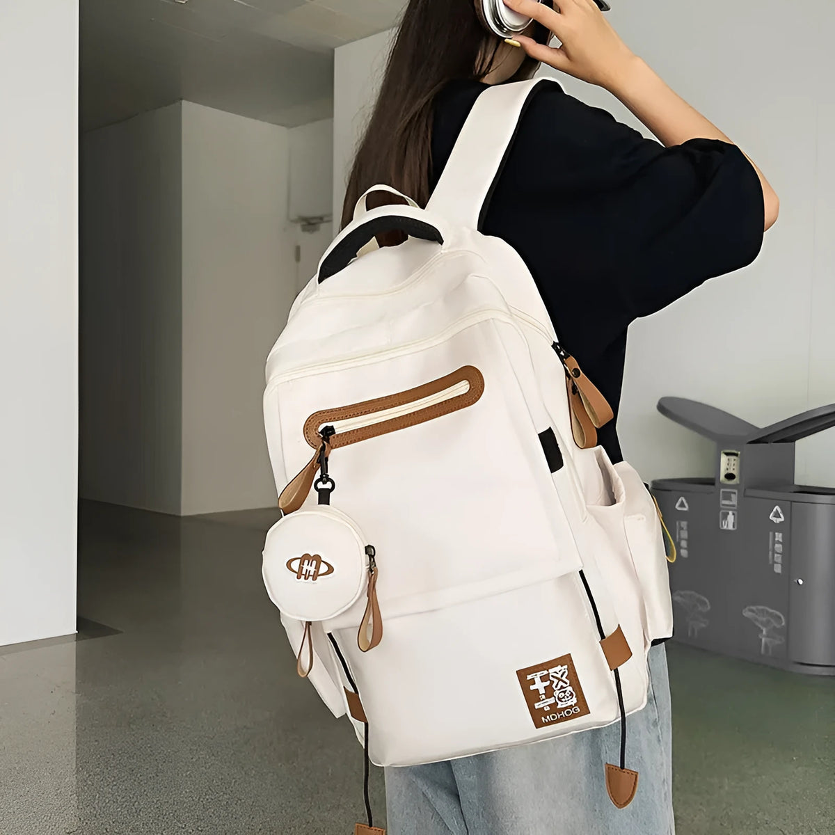 Large waterproof travel backpack in black with contrast colour stitching showing 20-35 litre capacity