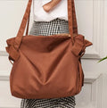 Women's black crossbody shoulder bag made from Oxford cloth with a large expandable storage compartment.