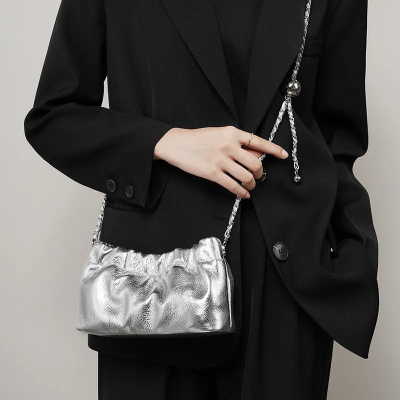 Women's genuine leather crossbody bag with chain strap in Black, Milky White, and Elephant Grey colours.