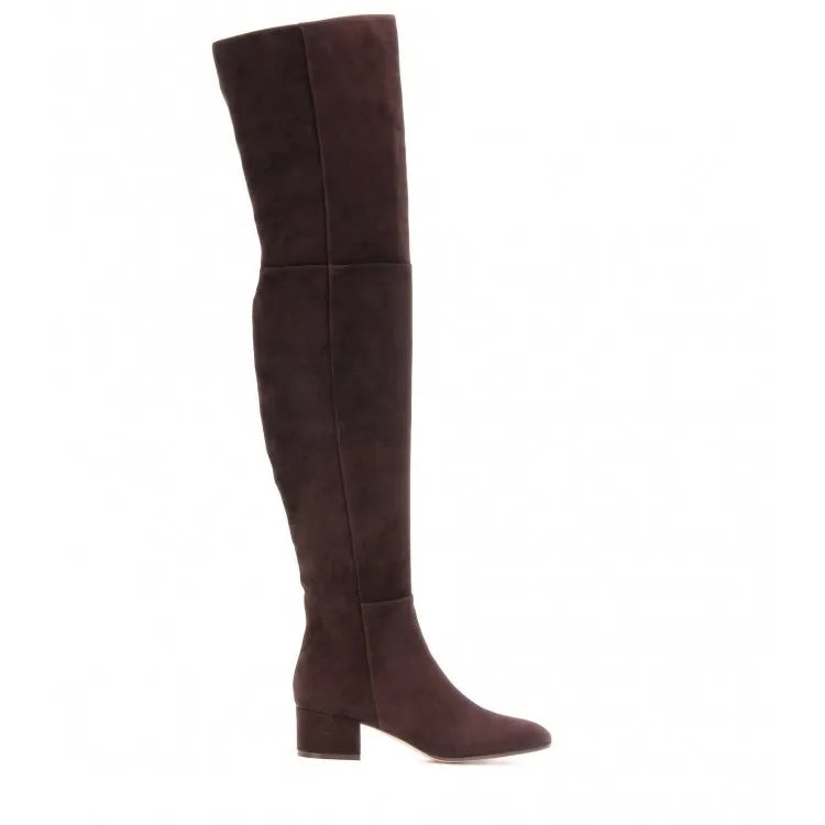 Women's grey suede over-the-knee boots with pointed toe and thick rubber sole on a wooden floor
