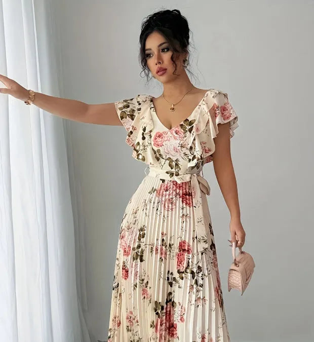 V-neck floral print dress with oversized swing skirt and ruffled sleeves in apricot colour, showing high waist and pleated details