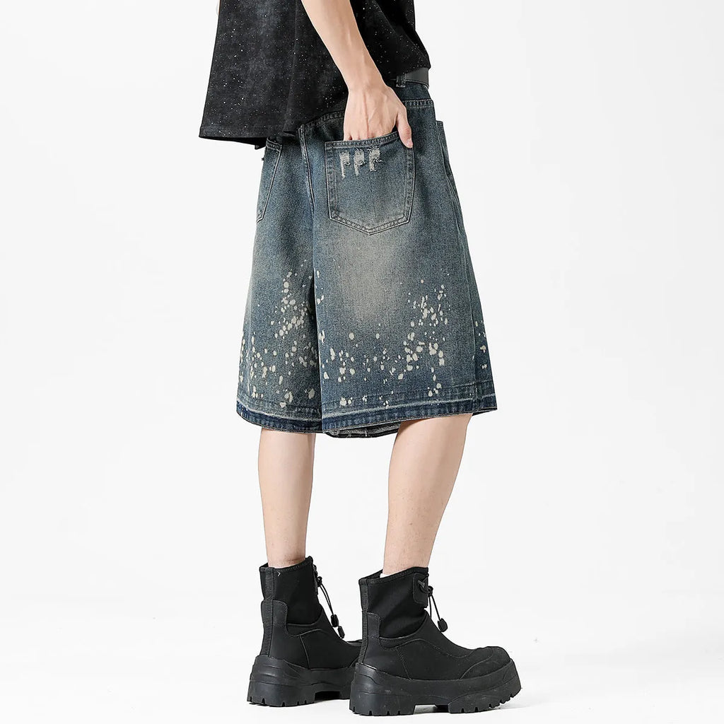 Men's retro washed blue denim shorts with five-point ripped splash ink design in straight cut