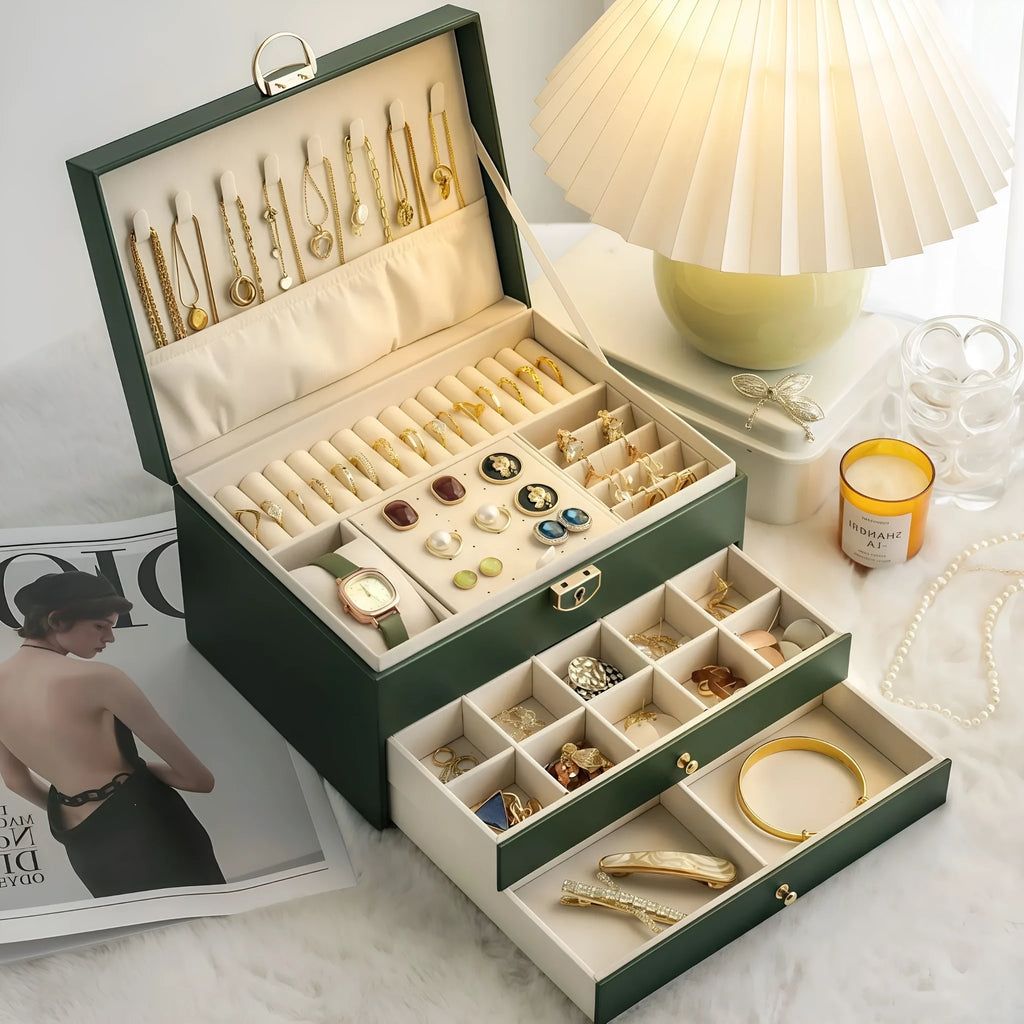 Leather jewellery storage box with three drawers open, showing storage for necklaces, earrings, and bracelets.