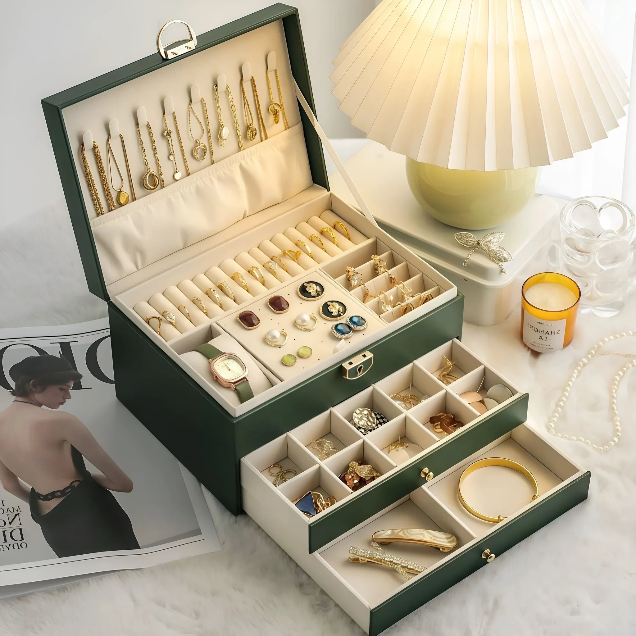 Leather jewellery storage box with three drawers open, showing storage for necklaces, earrings, and bracelets.